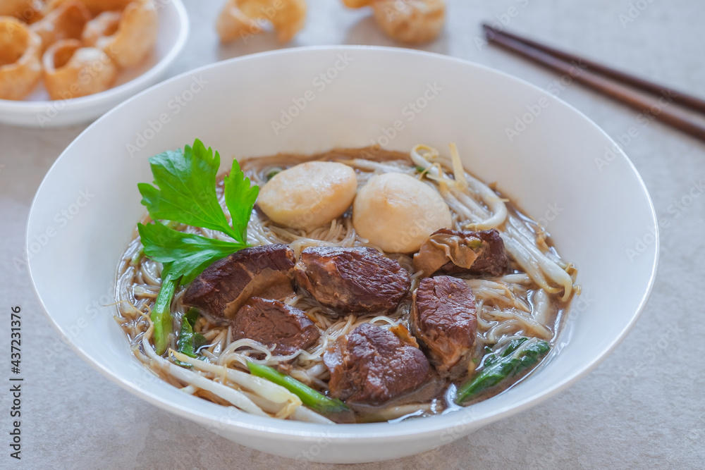 Noodle soup with braised pork and pork balls in bowl, Thai food style