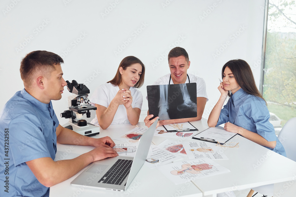X-ray of legs. Group of young doctors is working together in the modern office X-ray of legs. Group of young doctors is working together in the modern office