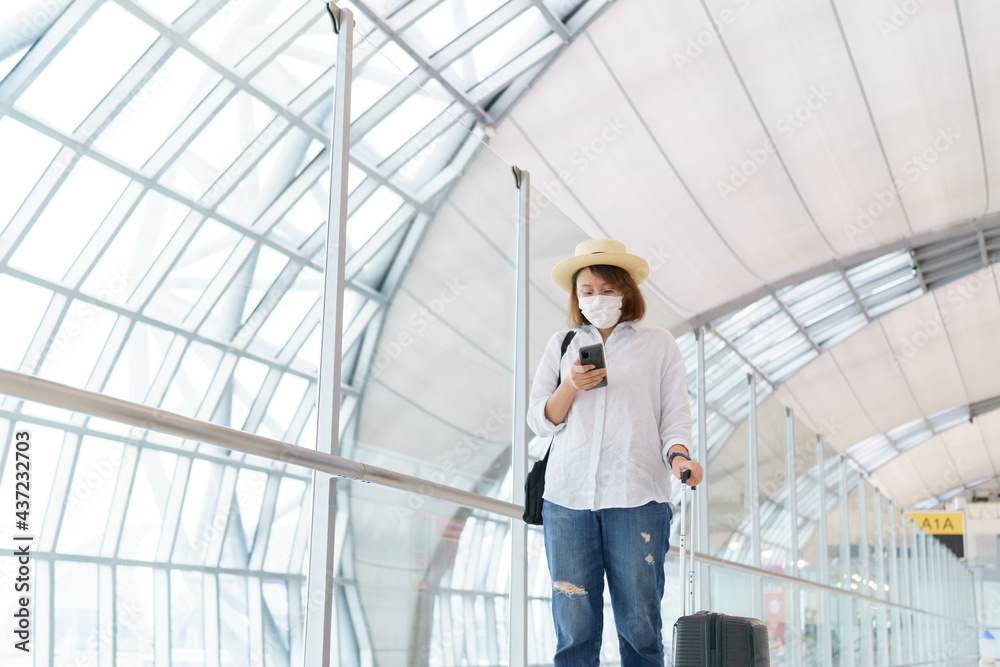 New Normal tourist wearing face mask is traveling on The airport , New lifestyle travel after covid-19. Social distancing healthcare system ,stay safe and Travel bubble concept.