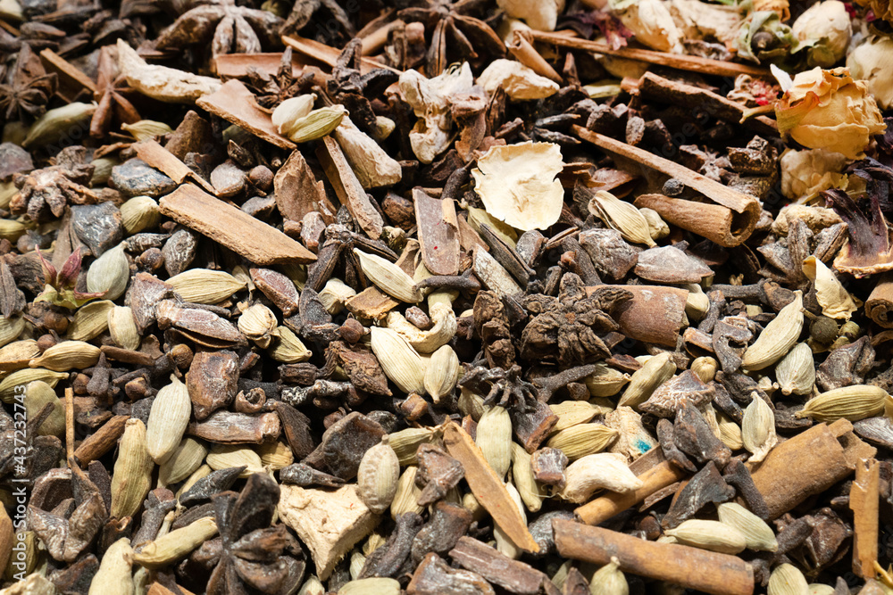 Texture of dry herbal tea with spices and fruits (hibiscus, star anise flowers and other). Selective focus Texture of dry herbal tea with spices and fruits (hibiscus, star anise flowers and other). Selective focus
