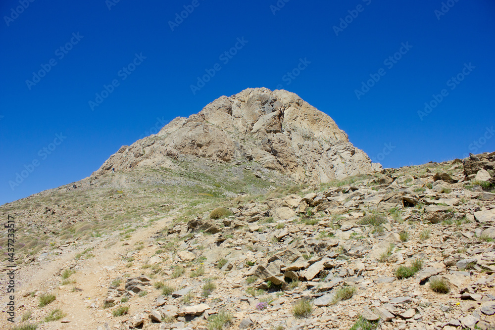 the top of the mountain under the blue sky
