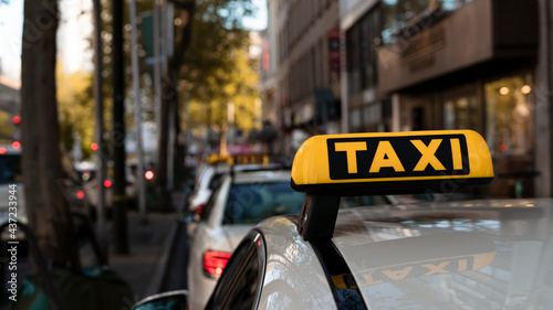 Yellow taxi on the street near the Christmas market in Berlin