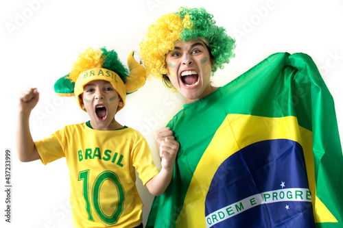 Amazing scene of Brazilian fans celebrating over white background. Family cheering together. Woman and little boy smiling.