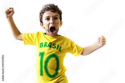 Brazilian boy, soccer player and fan, celebrates making a gesture with his hands over white background.  Sports fan cherring.