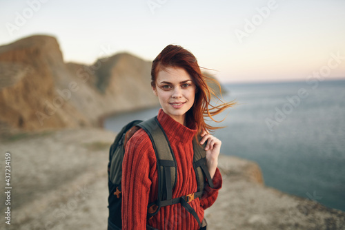 woman with backpack mountains landscape sea model tourism travel adventure