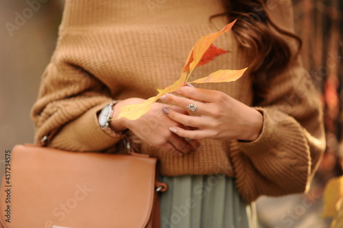 a girl with leaves in her hands