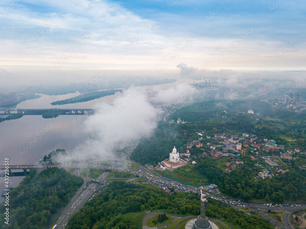 High flight above the clouds in Kiev. Spring morning. Aerial high view.