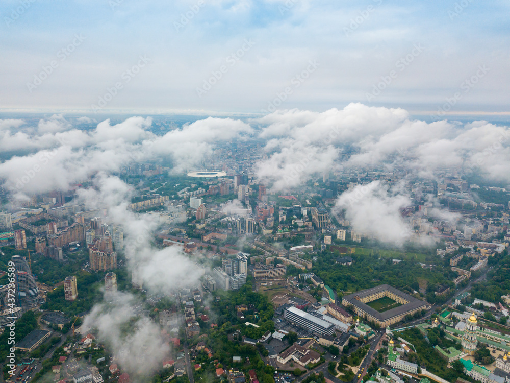 High flight above the clouds in Kiev. Spring morning. Aerial high view.