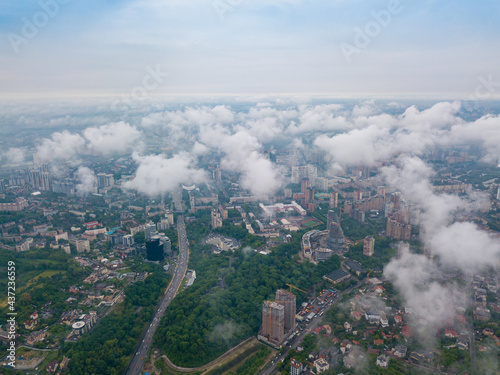 High flight above the clouds in Kiev. Spring morning. Aerial high view.