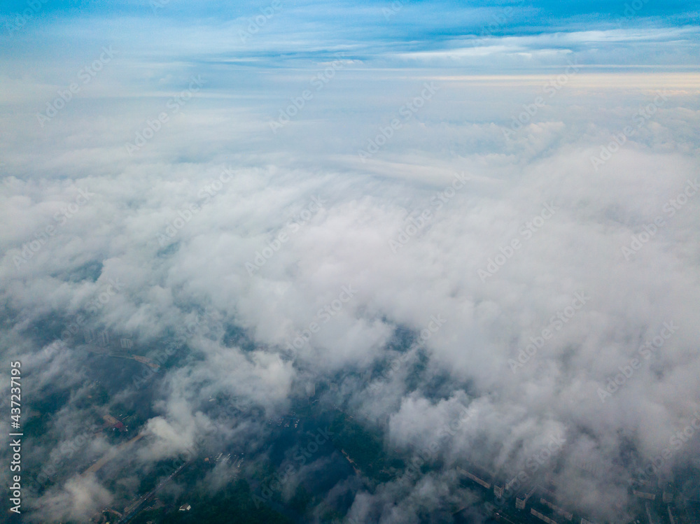 High flight above the clouds in Kiev. Spring morning. Aerial high view.