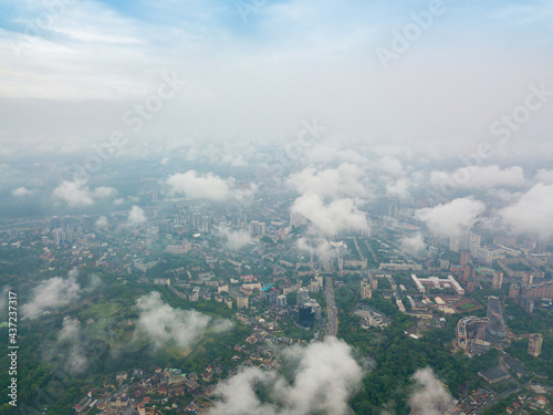 High flight above the clouds in Kiev. Spring morning. Aerial high view.