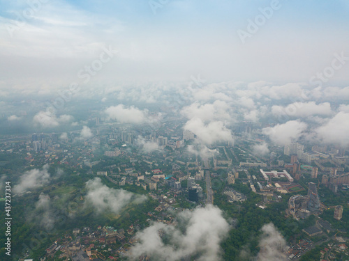 High flight above the clouds in Kiev. Spring morning. Aerial high view.