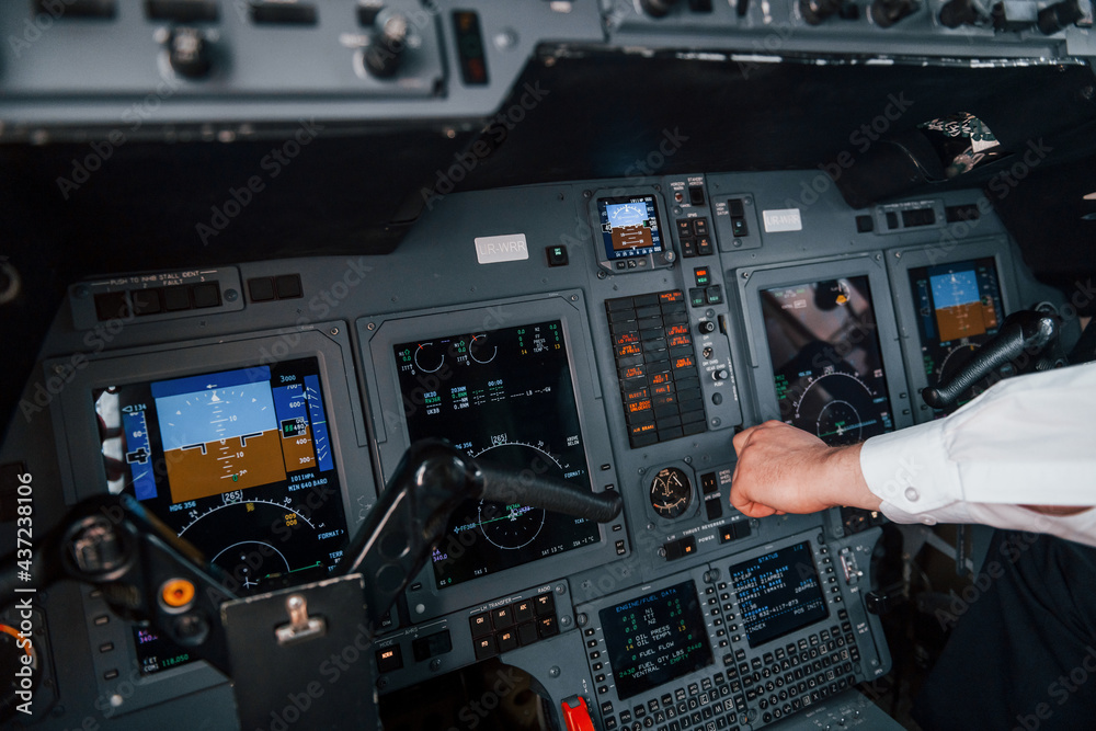 Fototapeta premium Close up view. Pilot on the work in the passenger airplane. Preparing for takeoff
