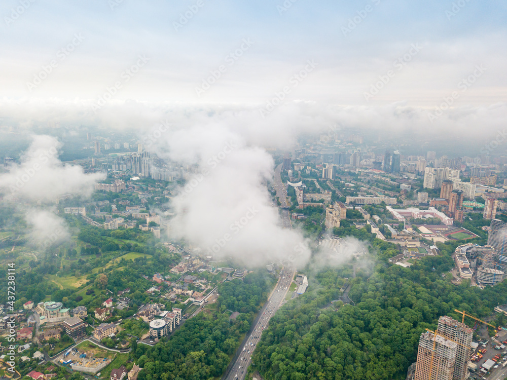 High flight above the clouds in Kiev. Spring morning. Aerial high view.