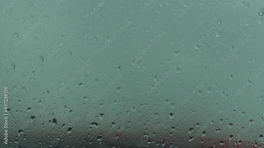 Flowing down water drops on glass. raindrops on the window, flow down. fall Flowing down water drops on glass. raindrops on the window, flow down. fall