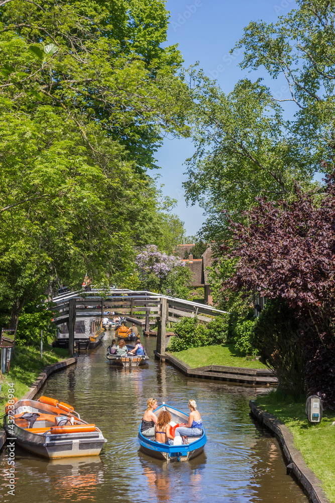 Naklejka premium Little electric boats going through the historic canal of Giethoorn, Netherlands