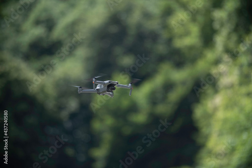 Drone hover in air with green background. 
