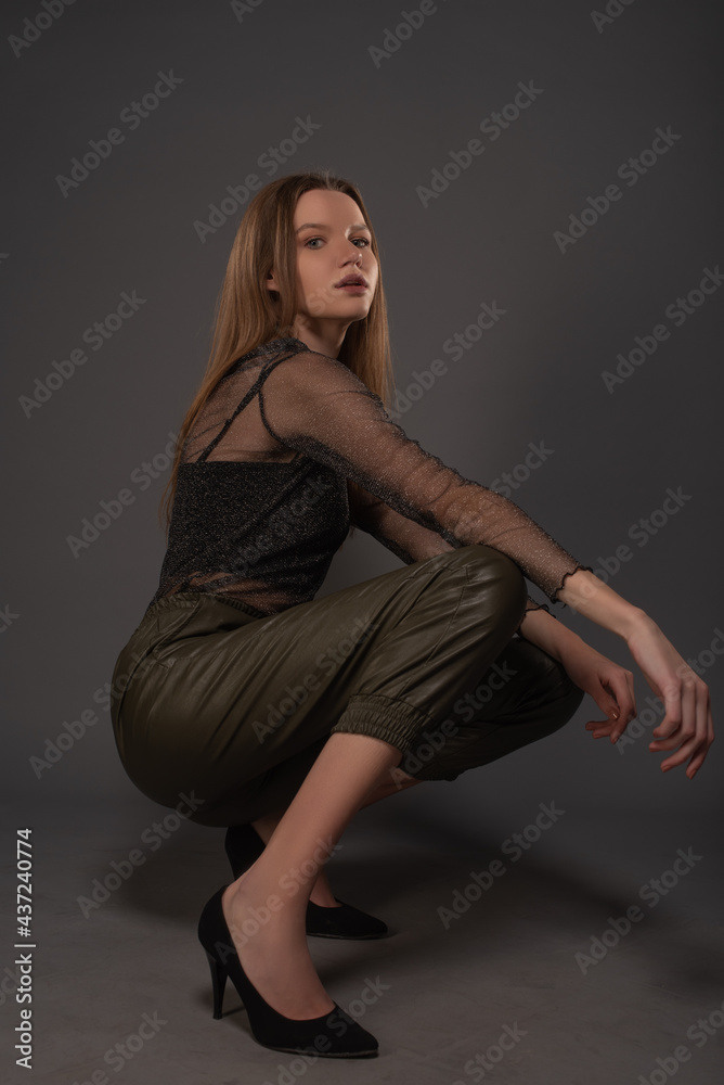 Fashion girl posing on grey background. Isolated Fashion girl posing on grey background. Isolated
