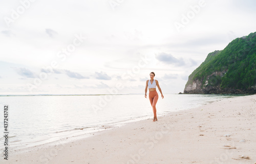 Happy woman strolling along seaside
