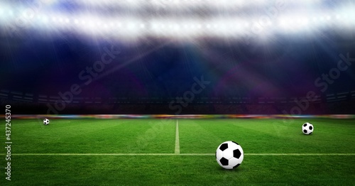 Composition of three footballs on football pitch with spotlights in sports stadium