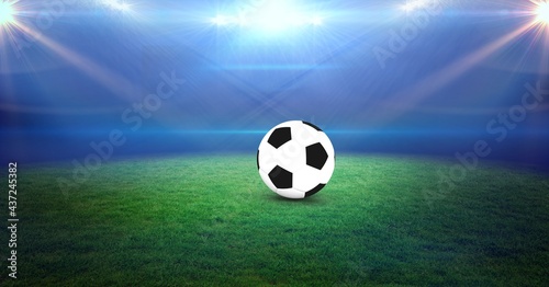 Composition of football on football pitch with spotlights in sports stadium © vectorfusionart
