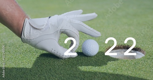 Composition of 2022 number with golf ball placed on golf course