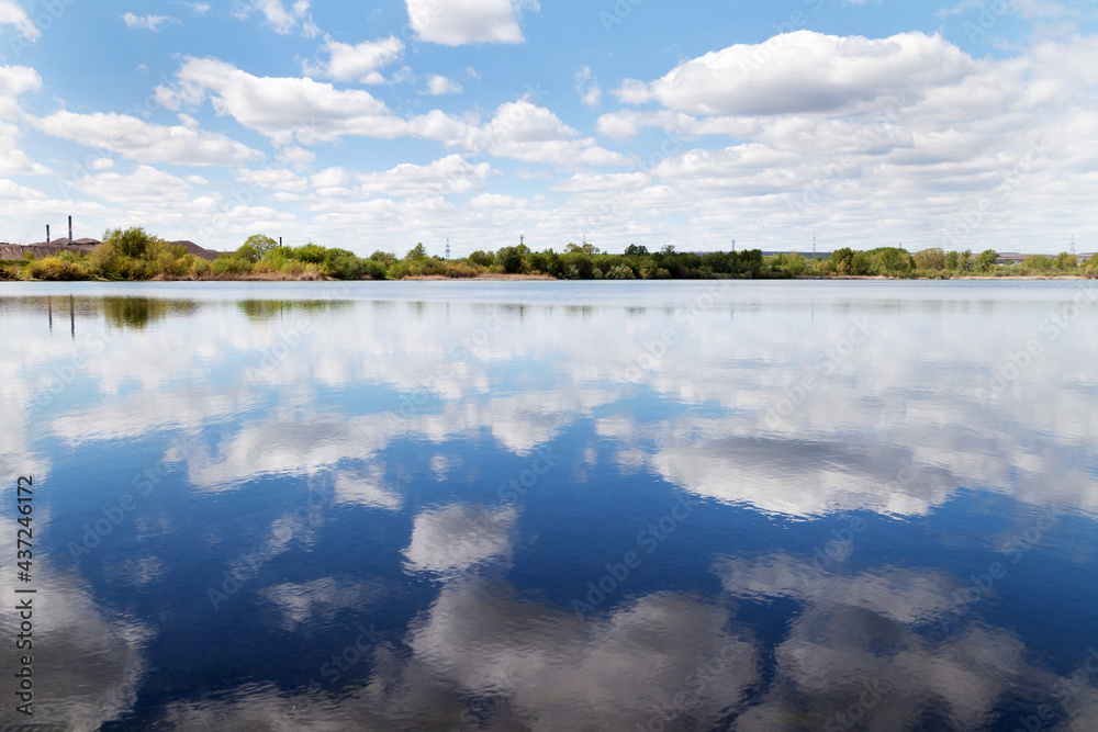 Reflection of clouds in the river on a clear summer day. Reflection of clouds in the river on a clear summer day.