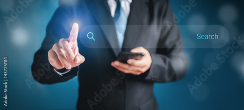 Wallpaper Mural Businessman touch the search button on the virtual screen to find strategy ideas internet technology information network for business with dark background. Torontodigital.ca