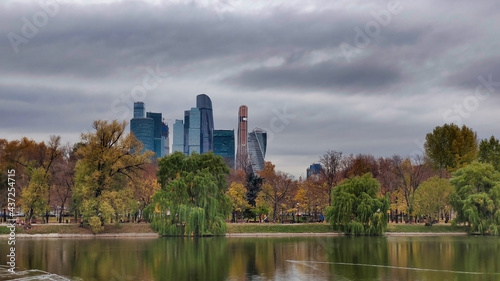 Park Novodevichy Ponds and view of Moscow City. Skyscrapers and cloudy weather. Lake in autumn. Russia. 