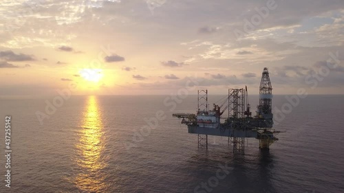 Aerial view of the jack up rig shot during sunset time. Fly around the jack up rig with a drone.
 photo