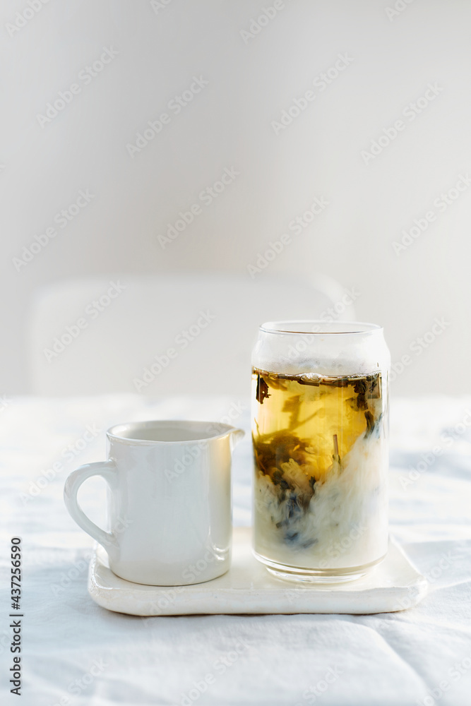 tea with milk on the table on a light background