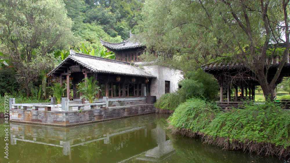 Jiangwan in Wuyuan County, Jiangxi Province, China. Jiangwan is an ancient town in Wuyuan County known for its Tang Dynasty architecture. Old building in a garden with trees and a pond. Jiangwan in Wuyuan County, Jiangxi Province, China. Jiangwan is an ancient town in Wuyuan County known for its Tang Dynasty architecture. Old building in a garden with trees and a pond.