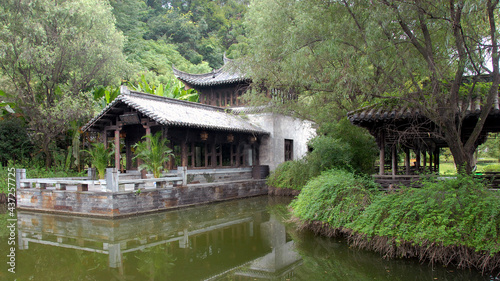 Jiangwan in Wuyuan County, Jiangxi Province, China. Jiangwan is an ancient town in Wuyuan County known for its Tang Dynasty architecture. Old building in a garden with trees and a pond. photo