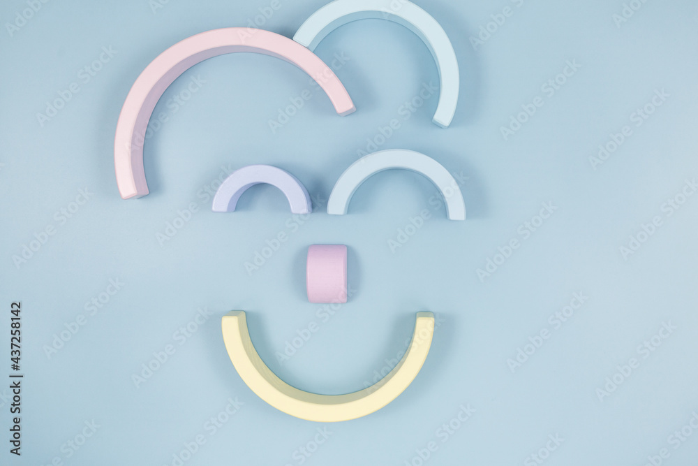 Funny face of smiling clown made with geometric shapes on blue background. Logic games, education, creativity tool for kids. Toys for kindergarten Funny face of smiling clown made with geometric shapes on blue background. Logic games, education, creativity tool for kids. Toys for kindergarten