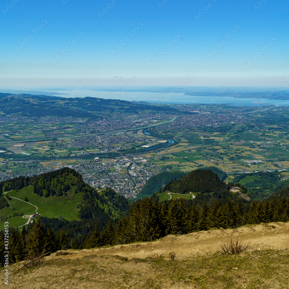 Aussicht von der Hohen Kugel über das Rheintal mit Dörfer und Städte bis zum Bodensee. springtime landscape with blooming meadows in Vorarlberg, Austria