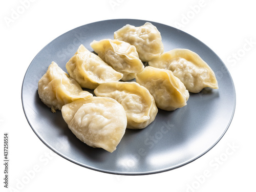 several boiled dumplings on gray plate isolated