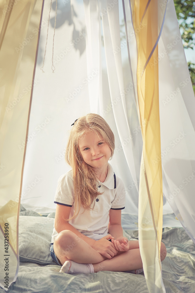 Little girl in white chiffon tent Little girl in white chiffon tent