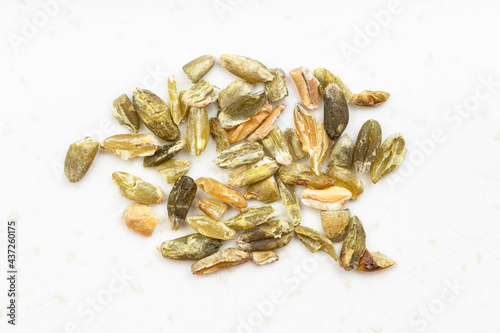 several freekeh wheat grains close up on gray photo