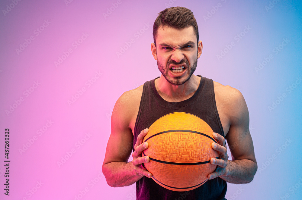 Angry european man hold basketball ball in hands Angry european man hold basketball ball in hands