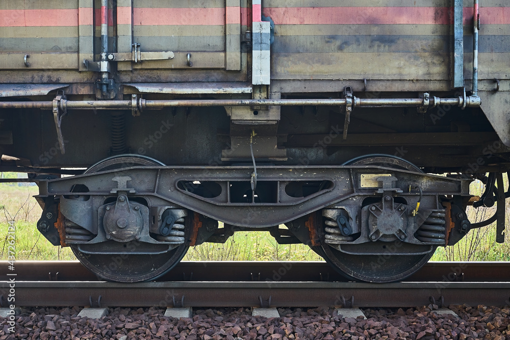 fragment of a train wagon with a close-up on the wheels fragment of a train wagon with a close-up on the wheels