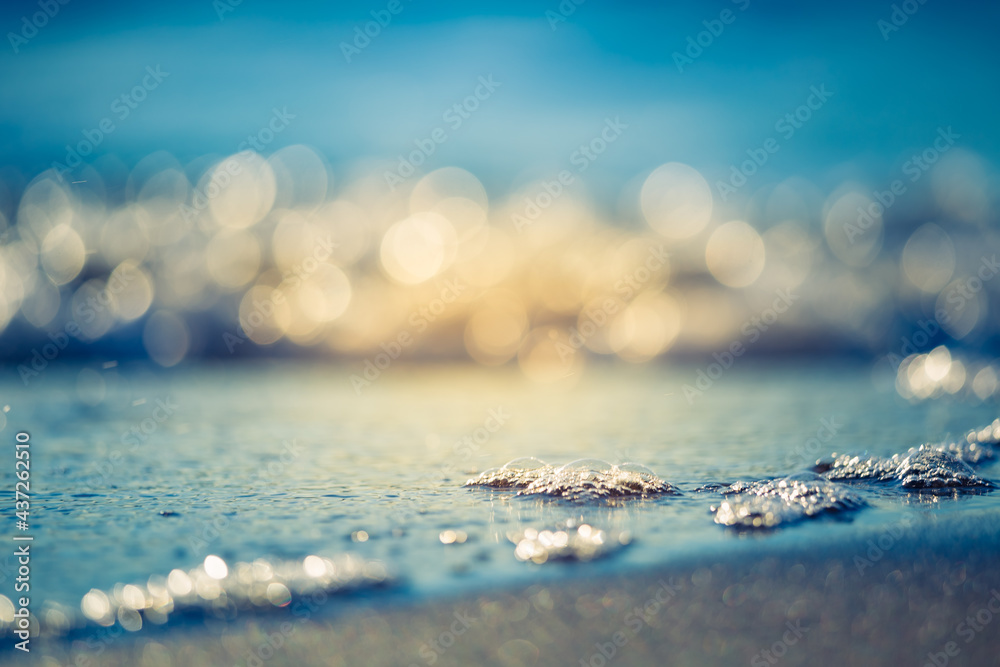 Beautiful small wawes on the sea sand at the beach. Sunset scenery of a Baltic Sea beach. Calm summer evening at seashore. - obrazy, fototapety, plakaty 