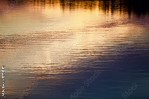 High-contrast shadows and bright reflections on the copper surface close-up. Bright ripples on copper water surface. Abstract backgrounds and textures. Copper surface close-up. Metal copper texture.