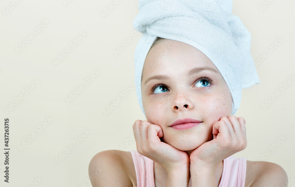 Portrait of beautiful little girl with fresh child skin. Kid in towel dreaming. Pretty baby cleansing procedures Portrait of beautiful little girl with fresh child skin. Kid in towel dreaming. Pretty baby cleansing procedures