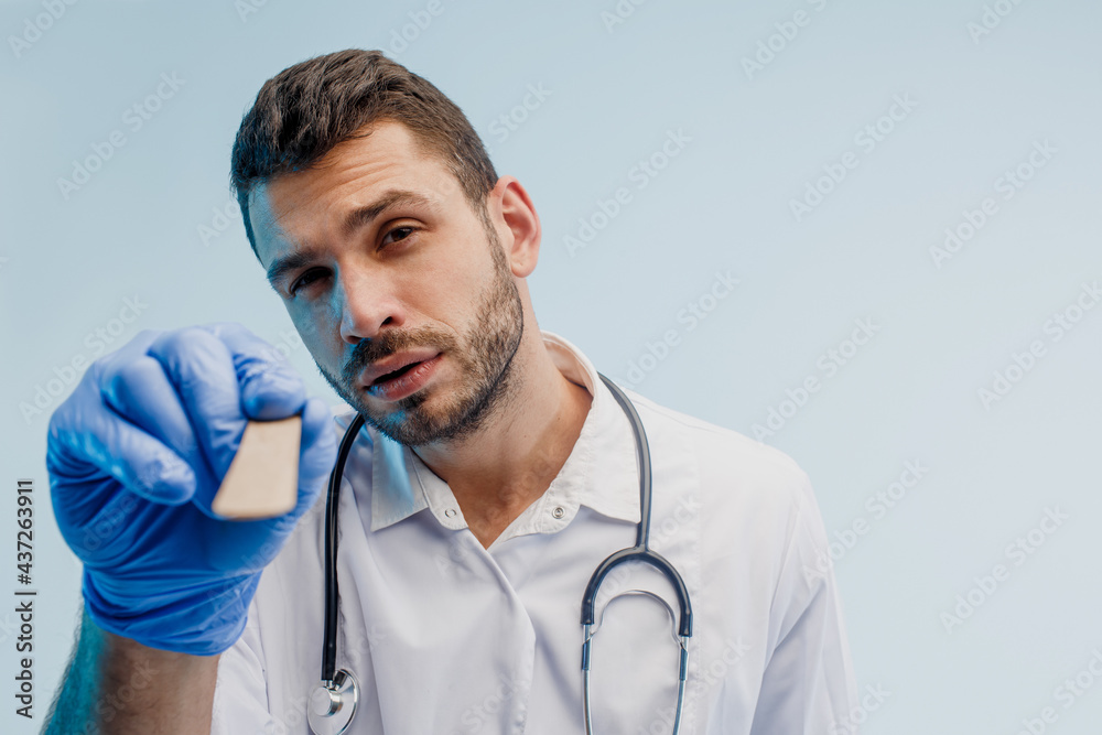 European male otolaryngology doctor with medical spatula European male otolaryngology doctor with medical spatula