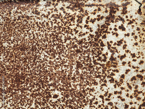 Rusty metal background. White painted metal texture with rust. Rust stains a lot.