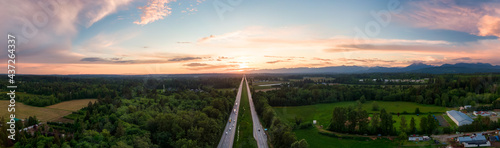 Aerial Panoramic View of Trans-Canada Highway 1 in Fraser Valley during colorful spring Sunset. Greater Vancouver, British Columbia, Canada.