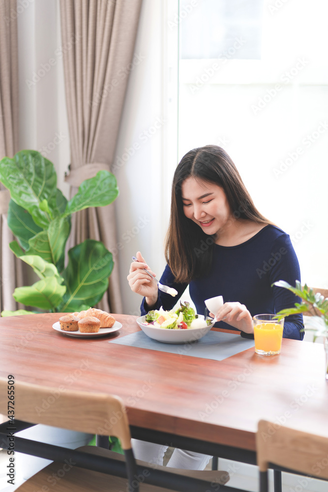 Portrait of happy playful asian girl eating fresh salad in diet concept Portrait of happy playful asian girl eating fresh salad in diet concept