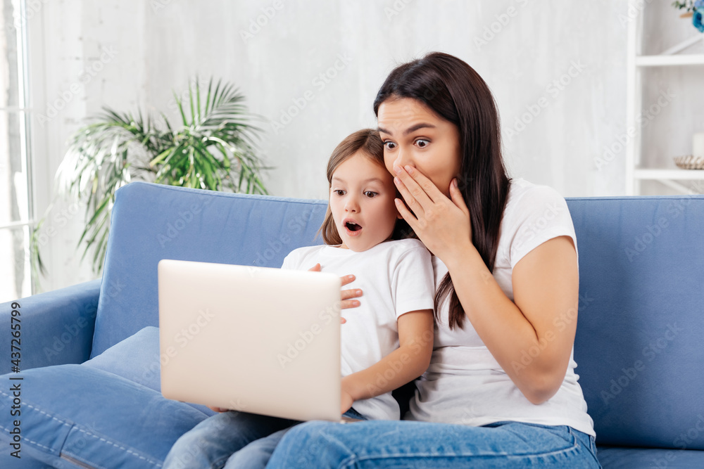Young female and her kid feeling astonished Young female and her kid feeling astonished