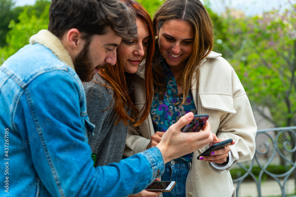 Young people using smartphone in hand – group friend with smart phone – social person in chat with mobile cell – digital touch and technology concept – cellphone for message