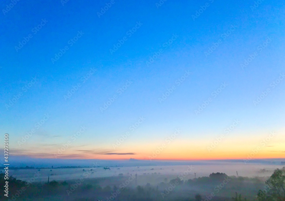 sunrise over the field in the fog
